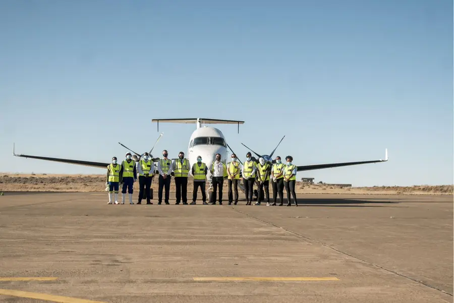 A Mohahlaula Airlines ground crew member walking towards a light aircraft