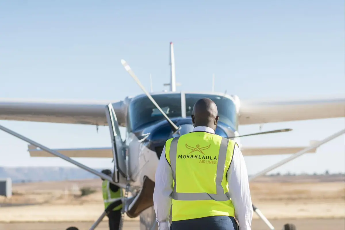 The Mohahlaula Airlines ground and flight crew standing together in front of a Beechcraft aircraft